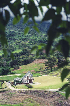 house surrounded by nature surrounded by mountains and trees. Feel the freshness without pollution. Dream house fog in morningの写真素材