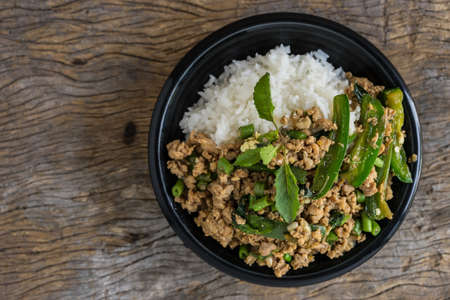 stir fried minced pork with basil with jasmine rice in bowl. thai popular street foodの写真素材