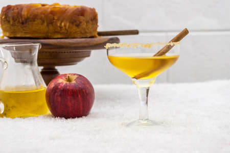 cold apple juice and cinnamon in glass and apple cake. focus at cinnamonの写真素材