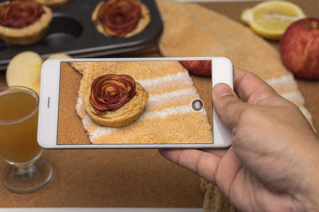 hand holding smartphone take a photo pie apple rose formの写真素材