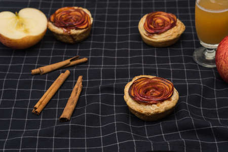 apple pie rose form with cinnamon, apple juice and fresh appleの写真素材