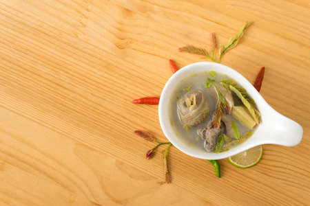 spicy chicken soup with tamarind leaf and herb in bowl. Thai food name "Tom Yum Kai". food for healthy dietの写真素材