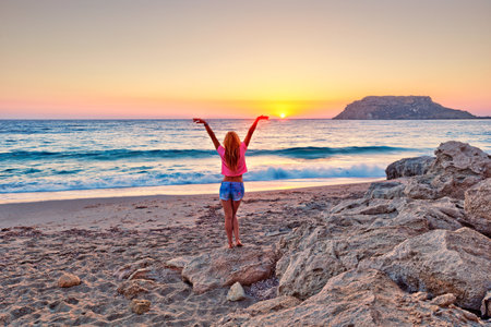 A woman at sunset in Fragolimnionas beach of Karpathos, Greeceの写真素材