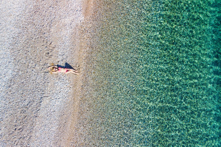 A beautiful woman at the beach Agios Dimitrios of Alonissos island from drone view, Greeceの写真素材