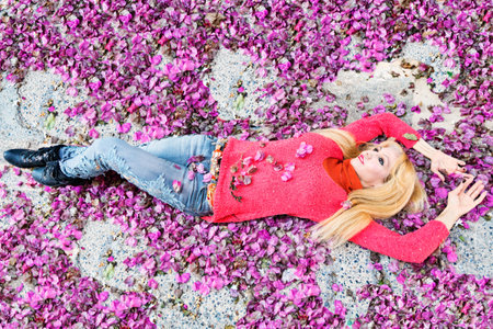 A woman between purple flower petalsの写真素材