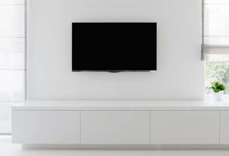 white living room detail tv on wall with commode and epoxy flooringの写真素材