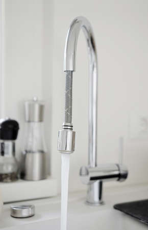image of water running from modern kitchen pipeの写真素材