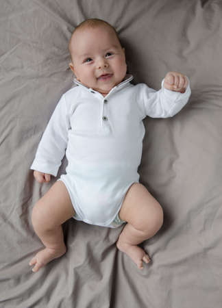 baby boy lying and smiling view from above