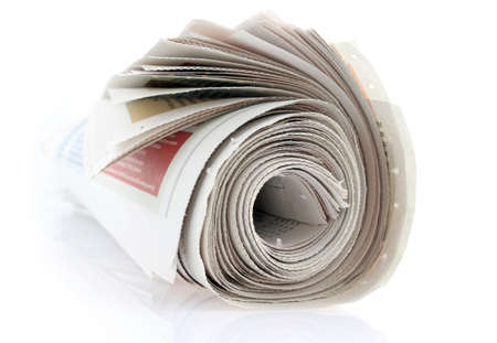 closeup of a newspaper roll on whiteの写真素材