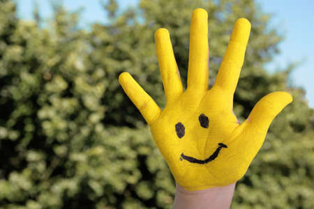 happy hand against treesの写真素材