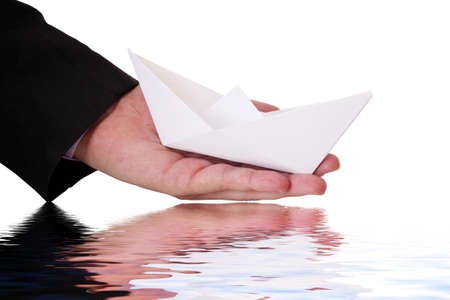 businessman is launching a paper boatの写真素材