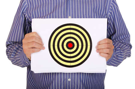 man is holding sheet of paper with a target drawn on itの写真素材