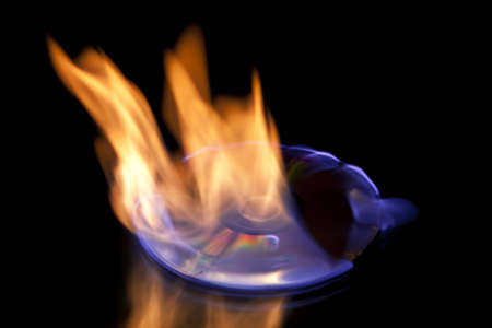 flaming cd on blackの写真素材