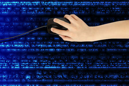 boy's hand with computer mouse on futuristic background 