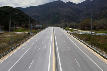 empty highway going through a mountain rangeの写真素材
