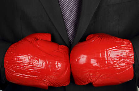 businessman is wearing boxing gloves 