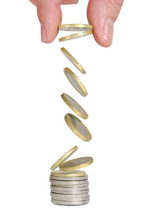 euro coins falling onto coin stack isolatedの写真素材
