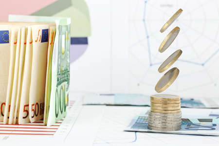 high speed image of coins falling onto coin stack の写真素材