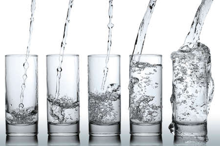 stages of pouring water into a glassの写真素材
