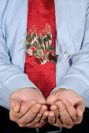 coins falling into businessman
