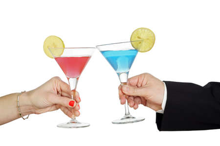 man and woman with cocktails toastingの写真素材