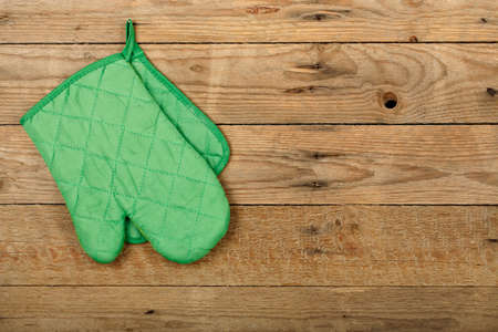 kitchen glove hung on old wooden surfaceの写真素材