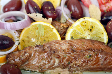 mackerel fillet with olives, onion rings and lemon slices