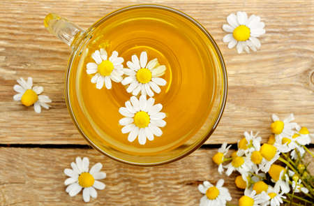 top view of cup of chamomile tea with chamomile flowersの写真素材