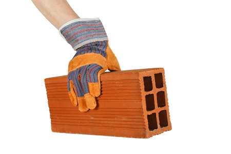 hand in protective glove placing a brick