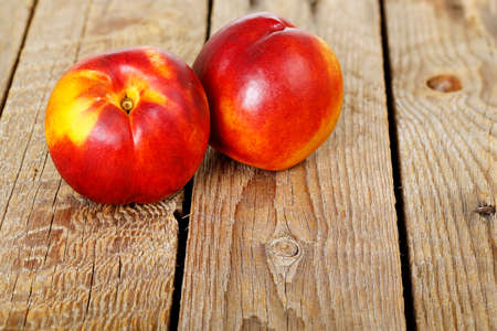 two fresh nectarines on woodの写真素材