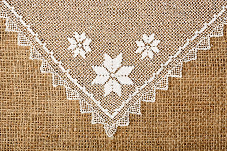 handmade doily on burlap for backgroundsの写真素材
