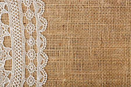 handmade doily on burlap for backgroundsの写真素材