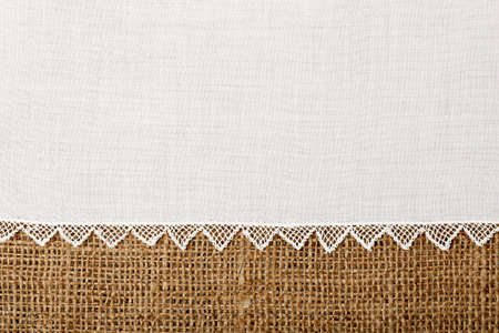 doily with handmade lace on burlap textureの写真素材