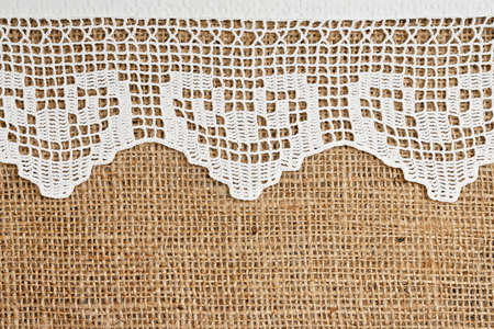 handmade lace on burlap for backgroundsの写真素材