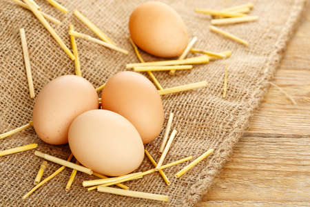 fresh eggs with hay on sackclothの写真素材