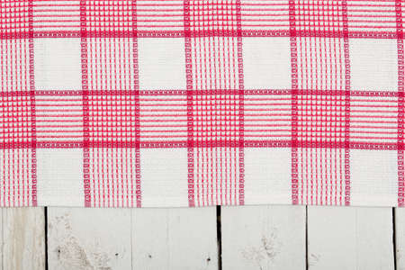 checked napkin over old white wooden planksの写真素材