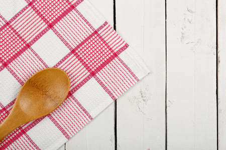 napkin and wooden ladle on white planksの写真素材