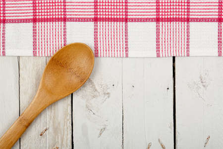 napkin and wooden ladle on white planksの写真素材