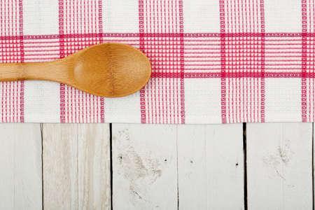 napkin and wooden ladle on white planksの写真素材