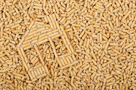 wood pellets in the shape of a house on wood pellets surface, full frame