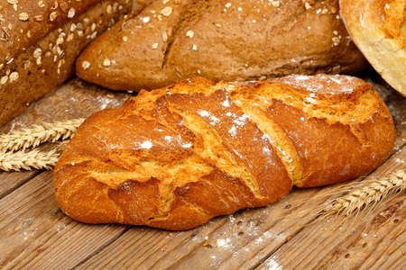 loaf of whole wheat bread on old wooden planks