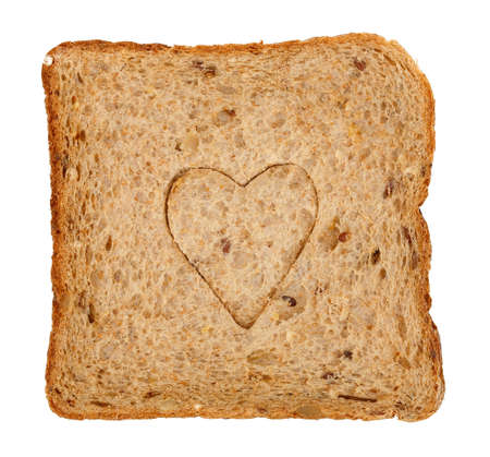 slice of whole wheat toast bread with heart shape isolated on white