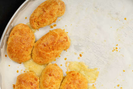 freshly baked homemade pastries filled with cheese on tray with baking paperの写真素材