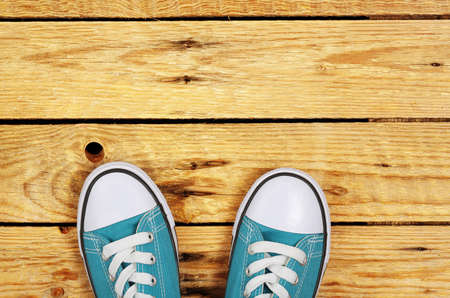 top view of sneakers on weathered wooden planksの写真素材