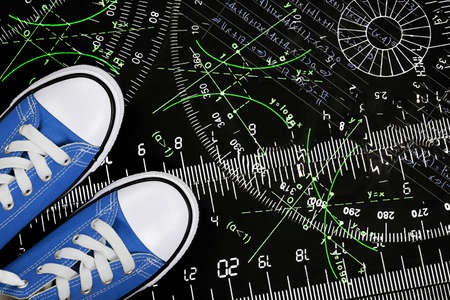 sneakers with rulers and mathematics on black surface, education conceptの写真素材