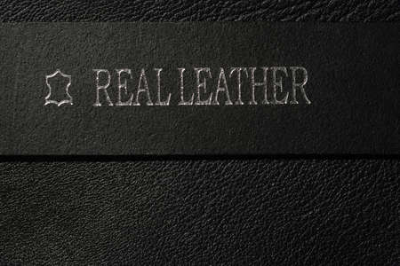 real leather written on black belt on leather surfaceの写真素材
