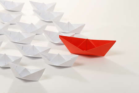 red paper boat leading white ones, leadership conceptの写真素材