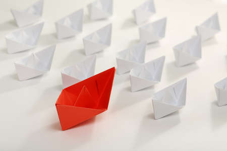 red paper boat leading white ones, leadership conceptの写真素材