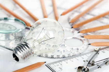 light bulb with rulers and pencils on desk, idea conceptの写真素材