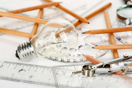 light bulb with rulers and pencils on desk, idea conceptの写真素材